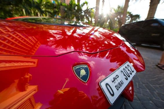Ein roter Lamborghini von vorne, zeigt ein vierstelliges Dubai-Nummernschild.