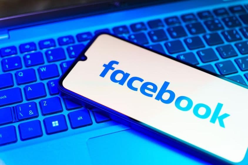 Facebook auf einem Telefon, darunter eine Tastatur.