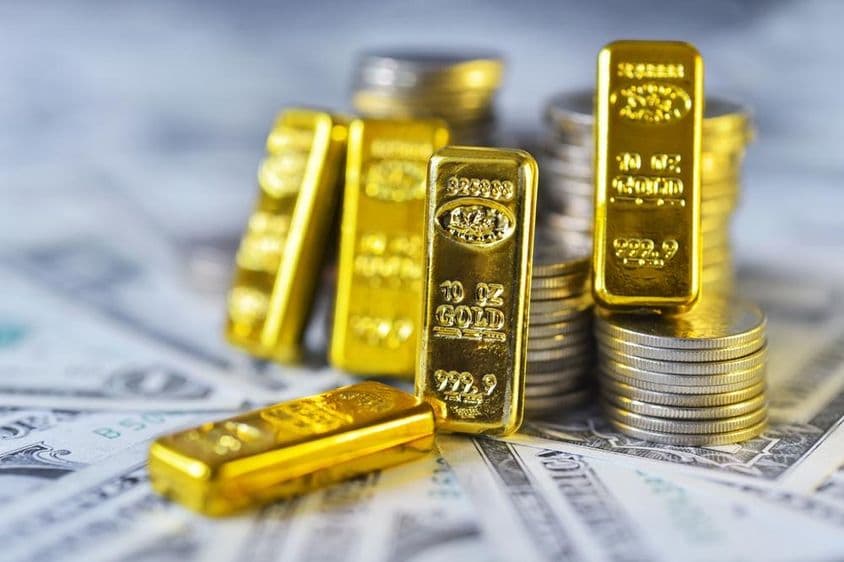 Anlagegold mit 999,9er Feinheit, auf Papier und Dollarmünzen ruhend.
