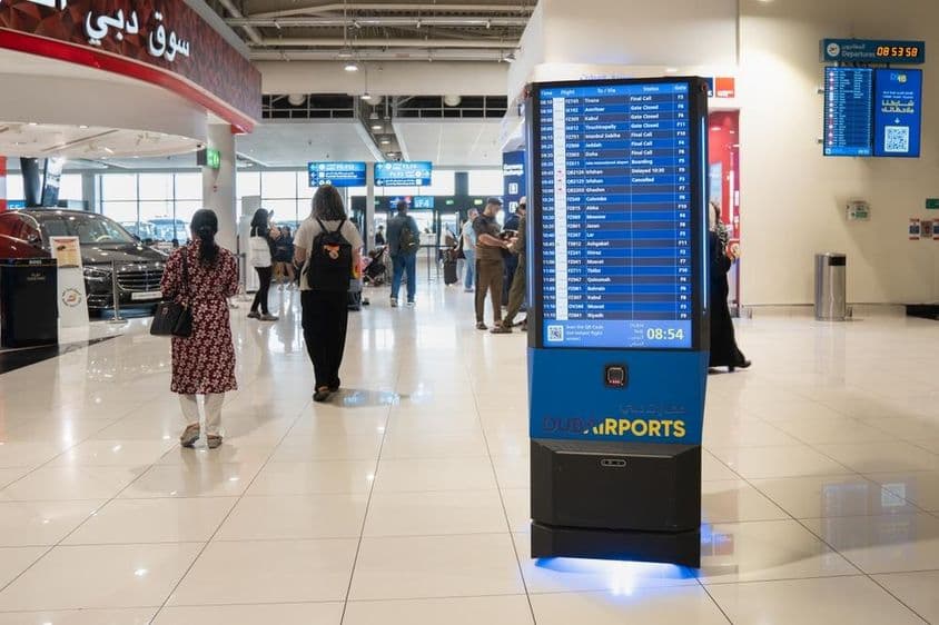 Innenansicht des Dubai Flughafens mit einem Informationsbildschirm.