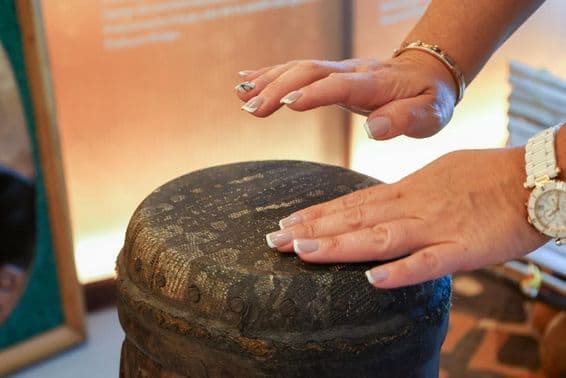 Dubai, Vereinigte Arabische Emirate, afrikanische Frau spielt auf einer Percussion-Trommel.