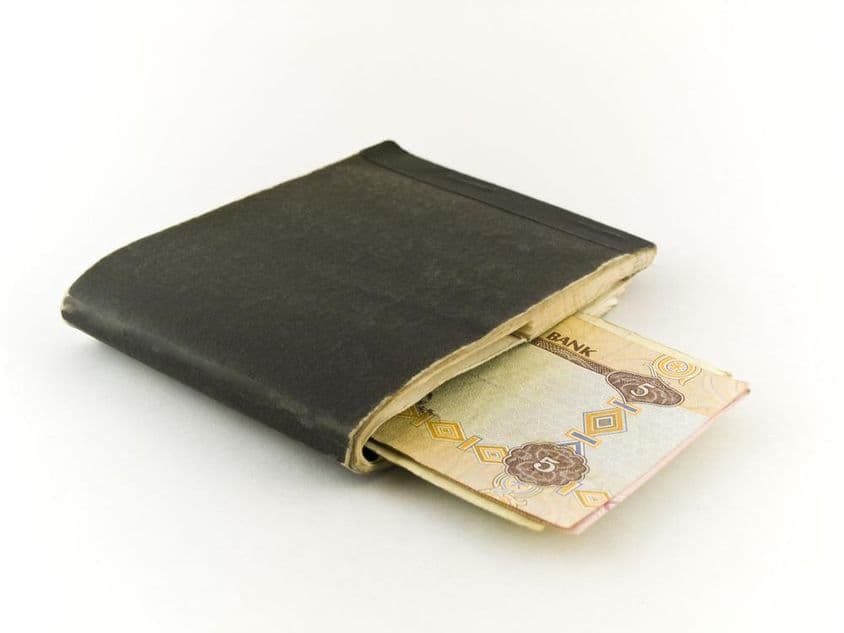 Altes Scheckbuch und Fünf-Dirham-Banknote.