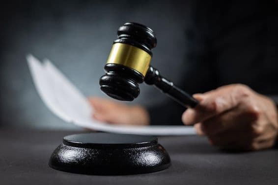 Richter verkündet Urteil mit Dokument im Gericht.