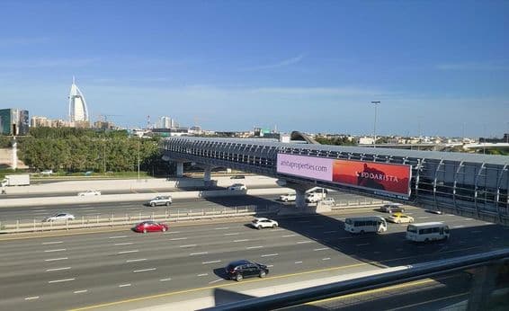Straße in Dubai, große Outdoor-Werbetafel an der Straße.
