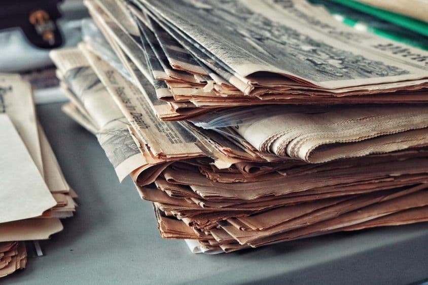 Alte Zeitungen gestapelt mit Spinnweben.