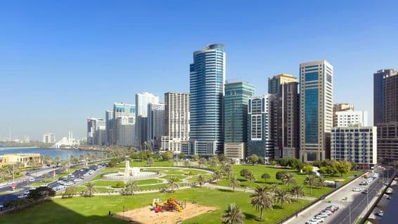 Weitläufige Rasenfläche und ruhiger Lagunenblick am Al Majaz Waterfront.