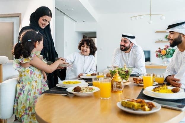 Glückliche arabische Familie zusammen zu Hause nach dem Abendessen während des Ramadan.