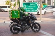 Motorradfahrer vom umweltfreundlichen grünen Lieferdienst von Careem.